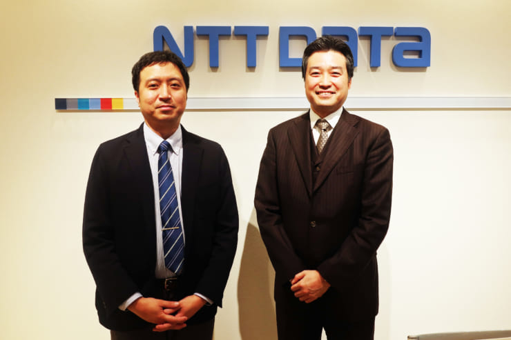 NTTデータ 金融事業推進部 デジタル戦略推進部部長 花谷昌弘氏（右）同　社会基盤ソリューション事業本部ソーシャルビジネス統括部課長 江島正康氏（左）