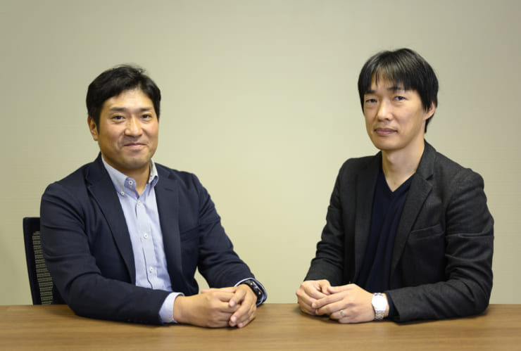 適応予測技術を開発したNEC中央研究所の吉田裕志氏（博士（工学））（右）と、NEC新事業推進本部の印南貴春氏（左）