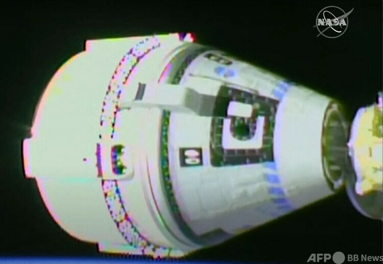 国際宇宙ステーション（ISS）にドッキングする新型宇宙船スターライナー（左）。米航空宇宙局（NASA）TV提供（2022年5月20日撮影）。(c)AFP PHOTO : NASA TV