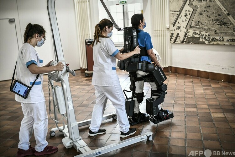 仏パリのアンバリッド病院でエグゾスケルトン（外骨格）のデモンストレーションをする医師（2022年11月9日撮影）。(c)STEPHANE DE SAKUTIN : AFP