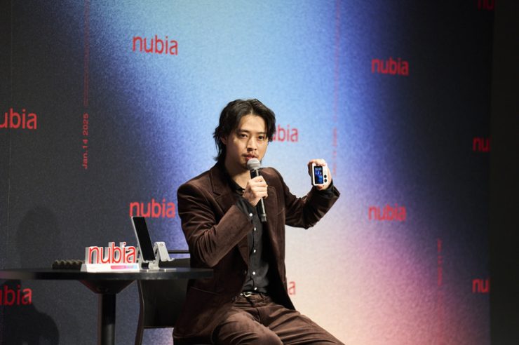 折り畳み式スマホ「nubia Flip 2」を持つ山崎賢人さん(2025年1月14日撮影)。(c)Xinhua News