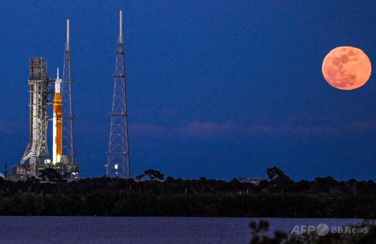 米フロリダ州ケネディ宇宙センターで、有人月探査ミッションのアルテミスIIスペース・ローンチ・システムロケットとオリオン宇宙船の発射台から見える満月（2026年2月1日撮影）。（c）Miguel J. Rodriguez Carrillo/AFP