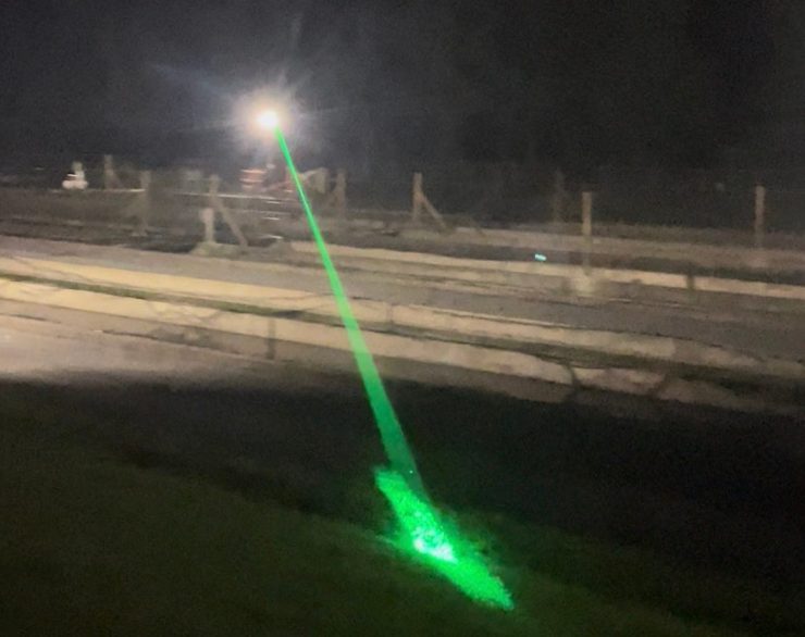 A laser beam is used to scare raptors like great blue herons at the Benner Spring State Fish Hatchery. A heron can eat several trout a day.