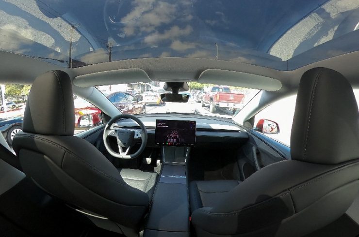 2月13日、渋滞するテキサス州オースティンの街を走るテスラのロボタクシー。REUTERS/Evan Garcia